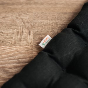 May include: Black quilted cushion with a white label that says "HEMP" and "hemplife" in green text.
