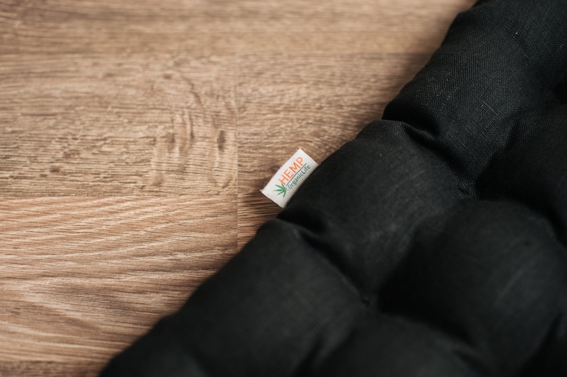 May include: Black quilted cushion with a white label that says "HEMP" and "hemplife" in green text.