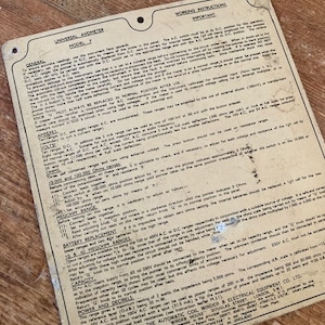 May include: Close-up of a vintage Universal Avometer Model 7 instruction manual. The manual is printed on yellowed paper with black text and includes detailed instructions for using the device, including information on ranges, ohms, megohms, and capacity.