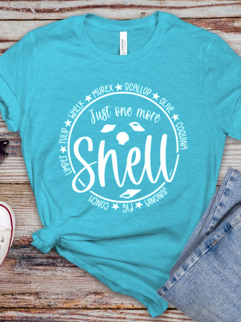 May include: A turquoise blue t-shirt with a white circle graphic that says "Just one more shell" with different types of shells around the text.