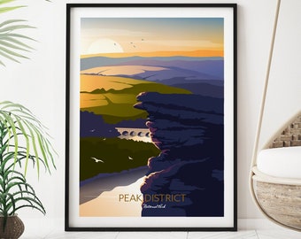 May include: A framed art print featuring a landscape scene of the Peak District National Park. The artwork depicts a cliffside view with a bridge, rolling hills, and a sunset in shades of orange, yellow, and blue. The words "PEAK DISTRICT" are printed at the bottom.