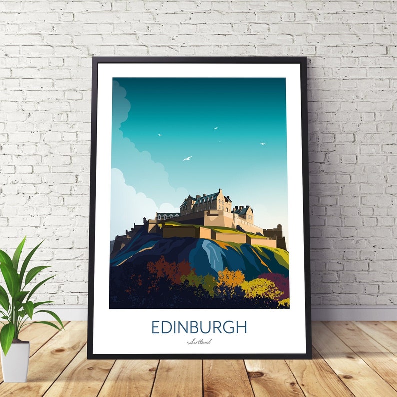 May include: A framed illustration of Edinburgh Castle in Scotland. The castle is depicted on a hill with a blue sky and white clouds in the background. The text "EDINBURGH" and "Scotland" is printed below the image.
