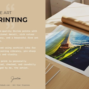 May include: A fine art print of a coastal landscape, with vibrant blues and greens, lies on a wooden table next to a rolled-up print. The text "FINE ART PRINTING" is displayed, along with details about archival inks and museum-quality prints.