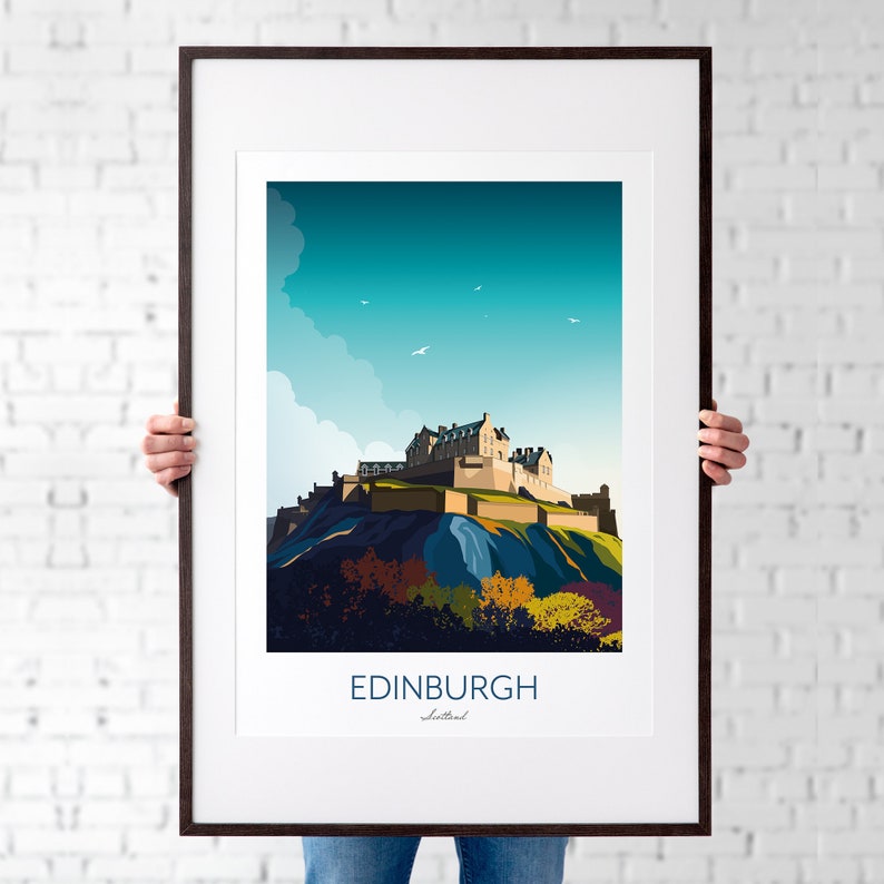 May include: A framed illustration of Edinburgh Castle in Scotland. The castle is depicted in a stylized, flat design with a blue sky and white clouds in the background. The text "EDINBURGH" and "Scotland" is printed below the image.