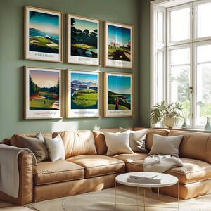May include: Six framed golf course art prints, each featuring a different course: Pebble Beach, Augusta, St Andrews, Pinehurst No. 2, TPC Scottsdale, and Whistling Straits. The prints are displayed on a green wall above a brown leather sectional sofa.