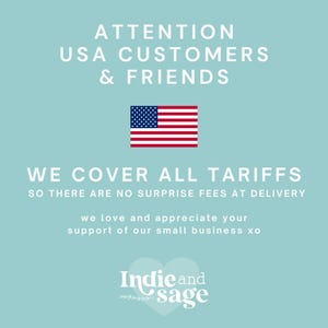 May include: A light blue background with the text "ATTENTION USA CUSTOMERS & FRIENDS" and an American flag. Below, the text reads "WE COVER ALL TARIFFS" and "SO THERE ARE NO SURPRISE FEES AT DELIVERY". The Indie and Sage logo is at the bottom.
