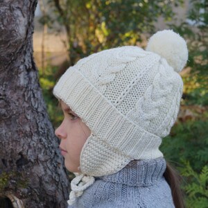 Pom pom beanie with ear flaps.Knitted girls/boys hat.Baby/toddler/child/teens knitted Hat.White hat.Hand knit merino hat.Winter Hat. image 1