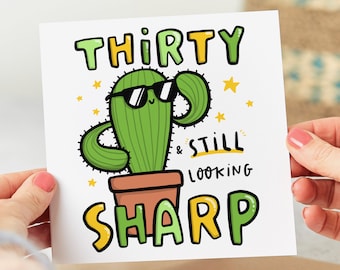 May include: A birthday card featuring a cartoon cactus wearing sunglasses with the text "Thirty & Still Looking Sharp".