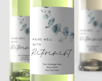 May include: A white wine bottle with a label that says "Pairs well with Retirement". The label has a watercolor design of eucalyptus leaves in shades of blue and green.