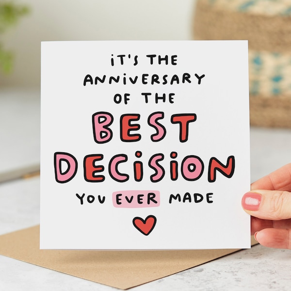 May include: White card with black and pink text that reads "It's the anniversary of the best decision you ever made" with a pink heart at the bottom.
