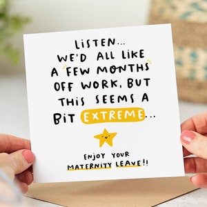 May include: A white card with black text that reads "LISTEN... WE'D ALL LIKE A FEW MONTHS OFF WORK. BUT THIS SEEMS A BIT EXTREME... ENJOY YOUR MATERNITY LEAVE!!"  A yellow star with a smiling face is below the text.