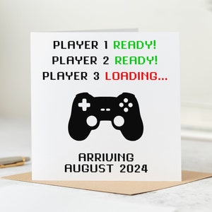 May include: A white card with black text and a black video game controller graphic. The text reads "PLAYER 1 READY! PLAYER 2 READY! PLAYER 3 LOADING... ARRIVING AUGUST 2024".