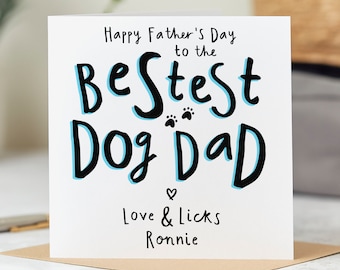 May include: A white card with blue and black lettering that reads "Happy Father's Day to the Best Dog Dad" with paw prints and a heart. The card also includes the text "Love & Licks Ronnie".