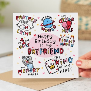 May include: A pink and white birthday card with colorful illustrations and the text "Happy Birthday to my Boyfriend". The card features phrases like "Partner in Crime", "My Whole World", "My Other Half", "My Perfect Match", "The King of My Heart", and "My Memory Maker".