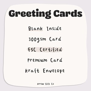 May include: A cream-colored card with the words "Greeting Cards" in bold black letters. The card details include "Blank Inside," "300gsm Card," "FSC Certified," "Premium Card," and "kraft Envelope." The Arrow Gift Co. logo is at the bottom.