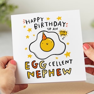 May include: A white card with a yellow egg wearing a party hat and the text "Happy Birthday to an Eggcellent Nephew" with stars and the words "that's you!" in a speech bubble.