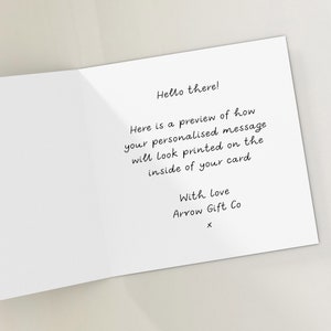 May include: A white card with black text that says "Hello there! Here is a preview of how your personalised message will look printed on the inside of your card With Love Arrow Gift Co X".