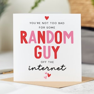 May include: A white card with pink and red lettering that reads "You're not too bad for some random guy off the internet". The card has small pink hearts at the top and bottom.