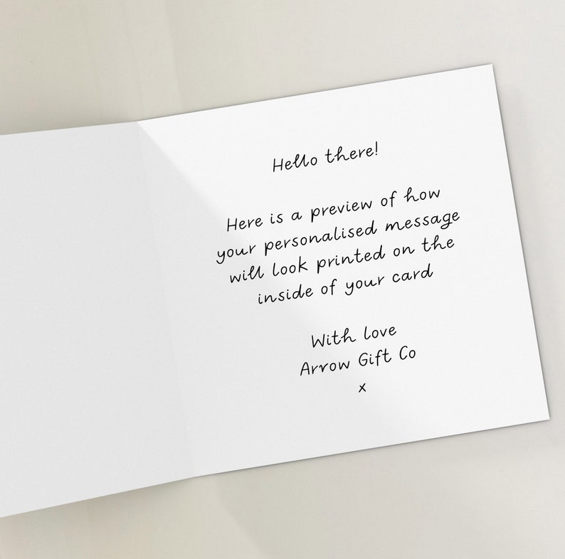 May include: A white card with a handwritten message that says "Hello there! Here is a preview of how your personalised message will look printed on the inside of your card. With love Arrow Gift Co X".