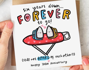 May include: A white card with a colorful illustration of two irons on an ironing board. The card says "Six years down... FOREVER to go! (still not BOARD of each other!!) Happy IRON Anniversary".