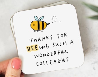 May include: White coaster with a yellow and black cartoon bee with the text "Thanks for bee-ing such a wonderful colleague".