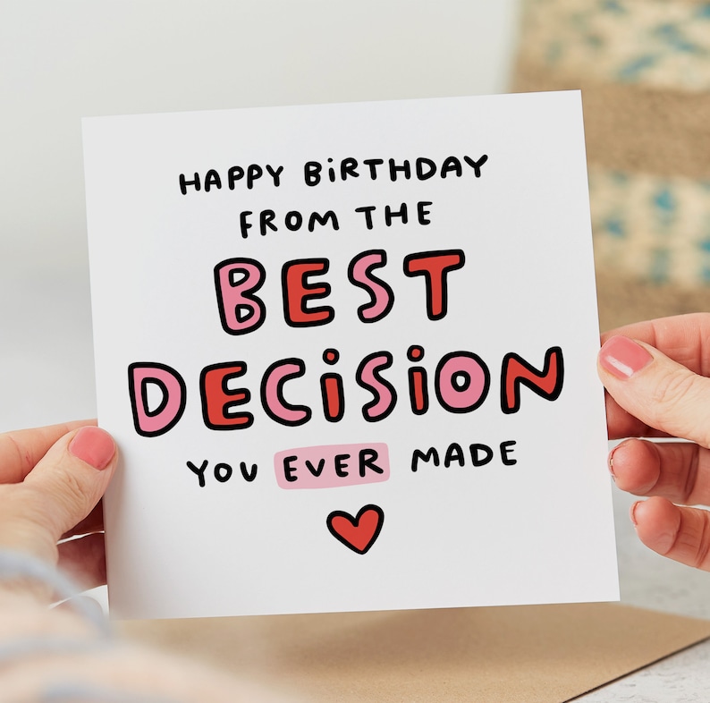 May include: A white card with a pink and red heart at the bottom. The card says "Happy Birthday from the Best Decision You Ever Made".