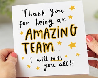 May include: A white card with black and yellow text that reads "Thank you* for being an* *AMAZING TEAM...* I will miss you all!!" with yellow stars scattered around the text.