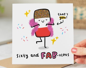 May include: A white card with a cartoon illustration of a chocolate bar wearing a pink feather boa and the text "that's you!" and "sixty and FAB-ulous".