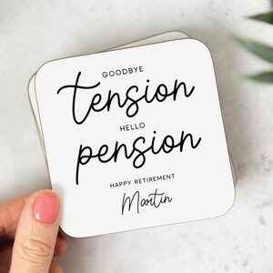 May include: White square coaster with black text that reads "Goodbye tension, Hello pension. Happy Retirement Martin".