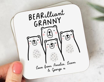 May include: White coaster with black text that reads "BEARilliant GRANNY" and features four cartoon polar bears. The text "Love from Amelia, Liam & George x" is printed below the bears.