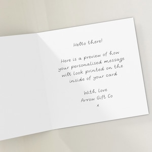 May include: A white card with a handwritten message that says "Hello there! Here is a preview of how your personalised message will look printed on the inside of your card. With love Arrow Gift Co X".