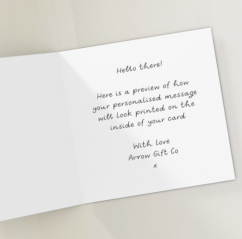May include: A white card with a handwritten message that says "Hello there! Here is a preview of how your personalised message will look printed on the inside of your card. With love Arrow Gift Co X".