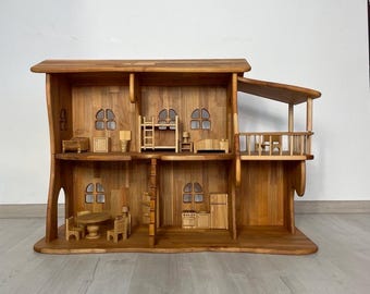 May include: A wooden doll's house with several rooms, including a kitchen, living room, and bedroom. The doll's house has a natural wood finish and features miniature furniture and accessories. The design includes a balcony and a ladder.