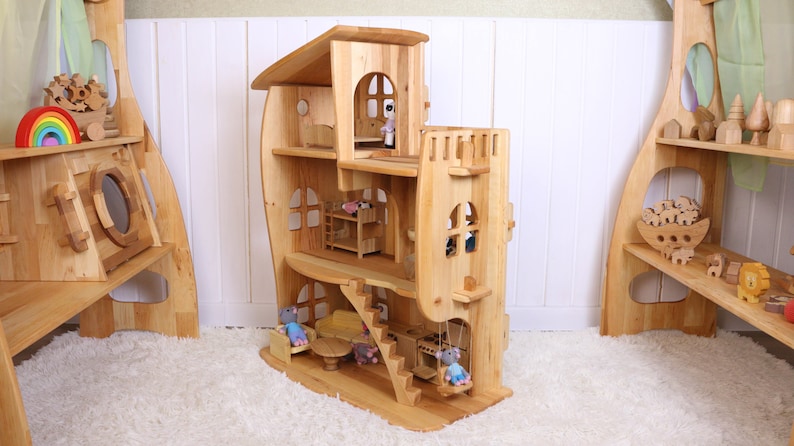 May include: A wooden dollhouse with a whimsical design, featuring multiple levels, windows, and a swing. The dollhouse is made of natural wood and has a light brown finish. The dollhouse is decorated with small wooden figures and furniture.