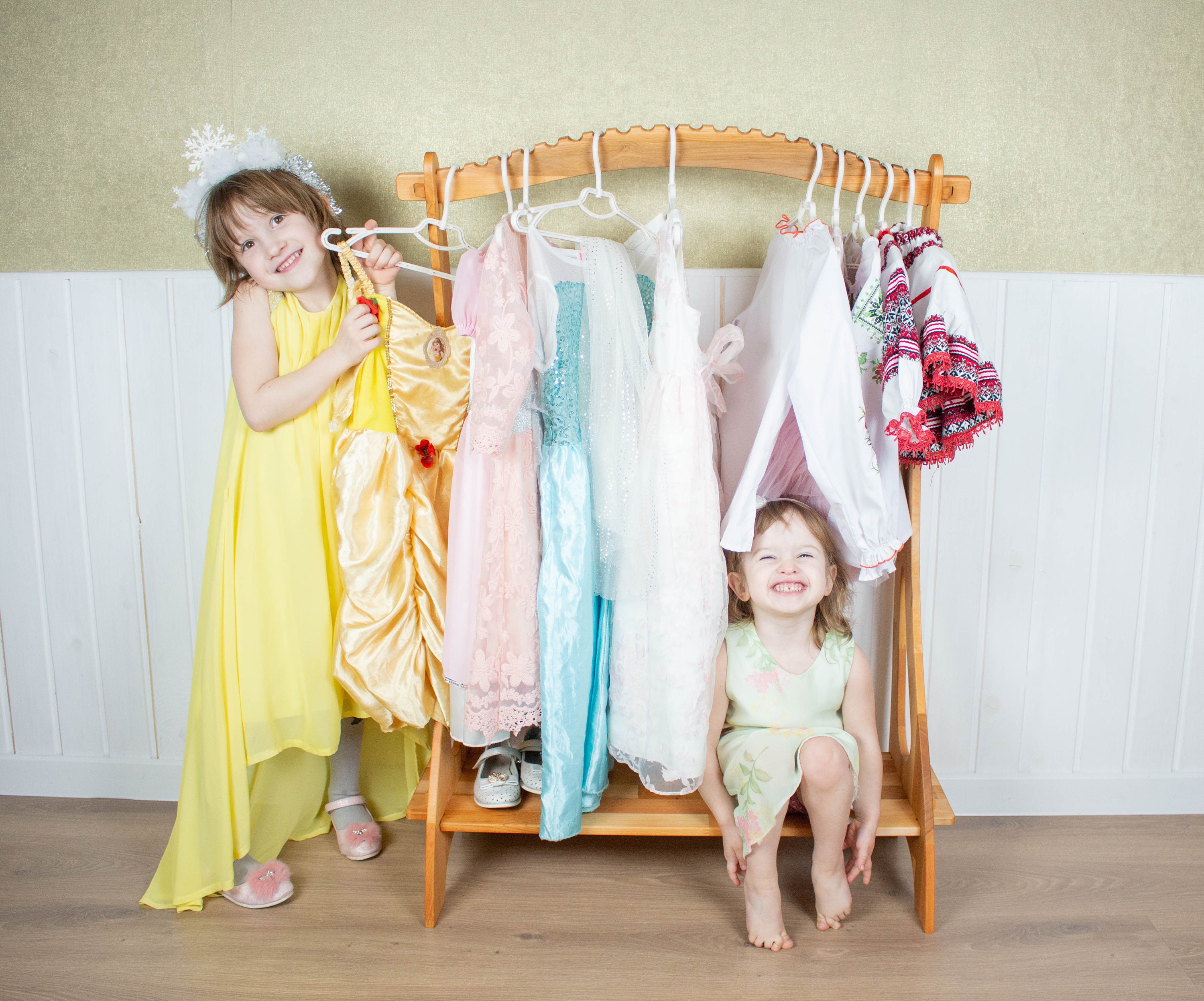 Premium Photo  Little 4yearold girl examines clothes hanging on hangers  the process of choosing children's clothes to buy