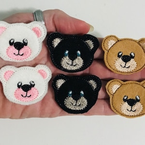 May include: Six felt appliques of different colored bears. Two white bears with pink noses, two black bears with brown noses, and two brown bears with tan noses.