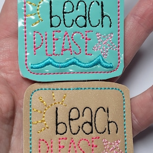 May include: Two embroidered patches with the text "beach please" in black and pink thread. The top patch is on a turquoise background with a yellow sun and a pink starfish. The bottom patch is on a brown background with a yellow sun and a pink starfish.