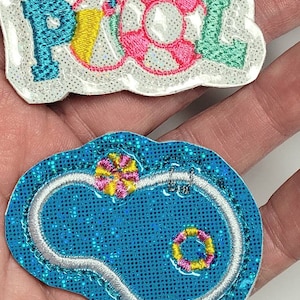 May include: Two iron-on patches with a summer pool theme. One patch is white with the word "POOL" in turquoise, yellow, pink, and green. The other patch is blue with a white outline of a pool with a pink and yellow inner tube and a pink and yellow life preserver.