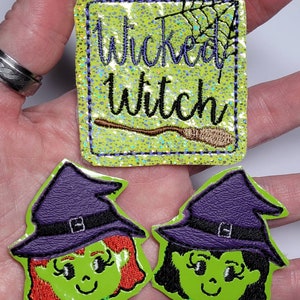 May include: Three Halloween-themed patches. The top patch is rectangular with the words "Wicked Witch" and a broom. Two witch face patches are below. All patches have a green background and purple, black, and brown accents.