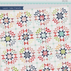 May include: A quilt pattern titled "Thimble Blossoms" by Camille Roskelley, labeled as "Layer Cake friendly." The quilt design features a repeating star pattern in various colors, including red, blue, green, and yellow. The quilt measures 71" x 71".
