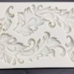 May include: Silicone mold with a design of three ornate, stylized leaves. The mold is white and has a smooth, glossy finish.
