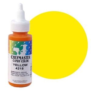May include: A bottle of Chefmaster Candy Color Yellow food coloring. The bottle is clear with a yellow liquid inside. The label is white with black text and a colorful logo. The text on the label reads "Chefmaster Candy Color Yellow 4215".