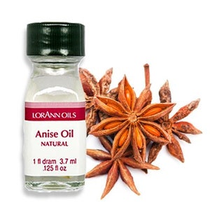 May include: A small glass bottle with a green lid and a red label that reads "Anise Oil NATURAL 1 fl dram 3.7 ml .125 fl oz"  The bottle is next to a group of star anise pods.