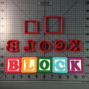 May include: A set of red plastic cookie cutters shaped like the letters B, L, O, C, K, and a circle. There are also two square cookie cutters. Below the cutters are five colorful blocks with the letters B, L, O, C, K printed on them.