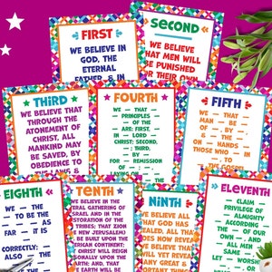 May include: A collection of rectangular posters titled Articles of Faith, each featuring colourful geometric borders and printed text. The posters are arranged in a group, accompanied by a pair of metal scissors and a small white ceramic sloth planter.