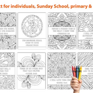 May include: A collection of eight coloring pages with intricate black and white designs and Bible verses. The pages feature floral, geometric, and abstract patterns. A hand holds a set of colorful crayons, suggesting the pages are for coloring.
