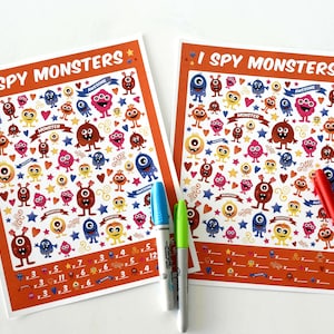 May include: Two orange and white printable "I Spy Monsters" activity sheets with colorful cartoon monsters, hearts, stars, and swirls. The sheets have a list of numbers and multiplication problems to solve.