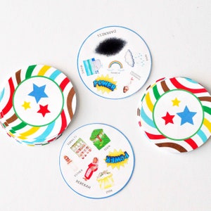 May include: A set of colorful, circular game cards with images and text. The cards feature themes of darkness, power, and the 12 tribes. The cards are designed for a game or activity.