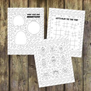 May include: Three black and white printable coloring pages featuring monsters. The first page has two blank monster outlines with the text "Make your own monsters!" The second page has eight different monster illustrations. The third page has a tic-tac-toe board with the text "Let's play tic tac toe!"