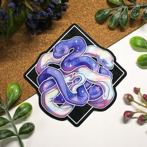 May include: A sticker featuring a colorful illustration of three snakes intertwined, with a galaxy-like pattern on their bodies. The snakes are a mix of purple, blue, and white, and are set against a black background.
